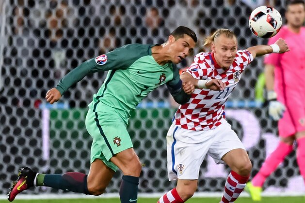 Portugal's Cristiano Ronaldo, left, challenges Croatia's Domagoj Vida during the Euro 2016 round of 16 soccer match between Croatia and Portugal at the Bollaert stadium in Lens, France, Saturday, June 25, 2016. (AP Photo/Geert Vanden Wijngaert)