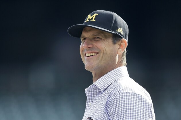University of Michigan head football coach Jim Harbaugh watches batting practice before a baseball game between the Detroit Tigers and the Oakland Athletics, Wednesday, April 27, 2016, in Detroit. (AP Photo/Carlos Osorio)