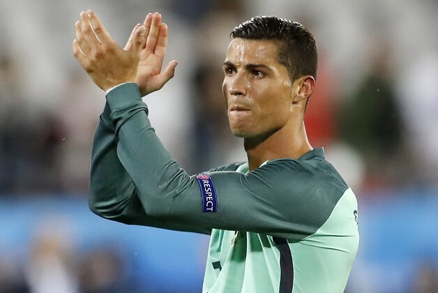 Portugal's Cristiano Ronaldo applauds fans at the end of  the Euro 2016 round of 16 soccer match between Croatia and Portugal at the Bollaert stadium in Lens, France, Saturday, June 25, 2016. Portugal won 1-0. (AP Photo/Frank Augstein)