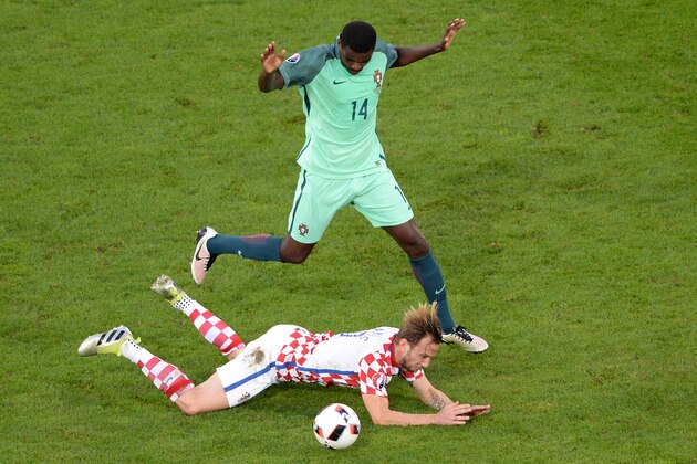 Croatia's midfielder Ivan Rakitic (bottom) falls on the pitch beside Portugal's midfielder William Carvalho during the Euro 2016 round of sixteen football match Croatia vs Portugal, on June 25, 2016 at the Bollaert-Delelis stadium in Lens. / AFP / FRANCOIS LO PRESTI        (Photo credit should read FRANCOIS LO PRESTI/AFP/Getty Images)