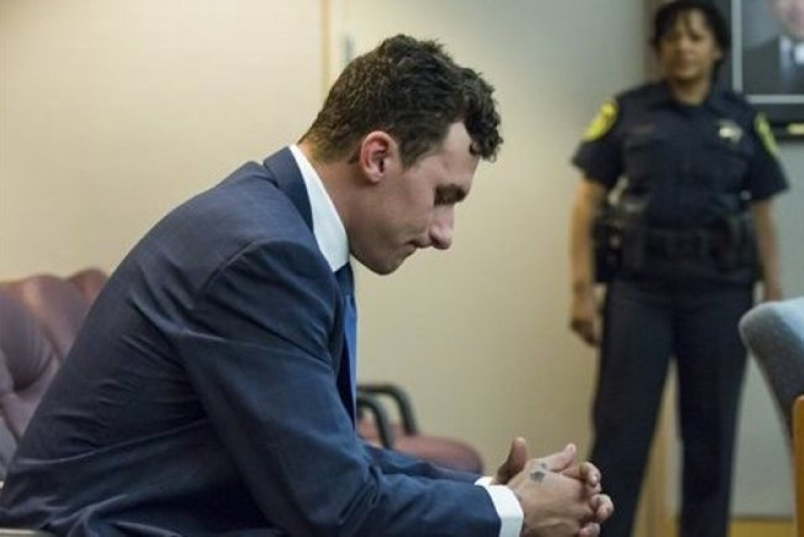Former Cleveland Browns quarterback Johnny Manziel sits at the back of the courtroom while his defense attorneys confer with the prosecution during his initial hearing, Thursday, May 5, 2016, in Dallas. The Heisman Trophy winner and former Texas A&M star was indicted by a grand jury last month after his ex-girlfriend alleged he hit her and threatened to kill her during a night out in January. No plea was entered, but defense attorney Robert Hinton says Manziel plans to plead not guilty. (Smiley N. Pool/The Dallas Morning News via AP, Pool) Former Cleveland Browns quarterback Johnny Manziel sits at the back of the courtroom while his defense attorneys confer with the prosecution during his initial hearing, Thursday, May 5, 2016, in Dallas. The Heisman Trophy winner and former Texas A&M star was indicted by a grand jury last month after his ex-girlfriend alleged he hit her and threatened to kill her during a night out in January. No plea was entered, but defense attorney Robert Hinton says Manziel plans to plead not guilty. (Smiley N. Pool/The Dallas Morning News via AP, Pool)