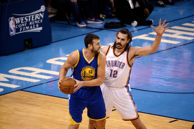 OKLAHOMA CITY, OK - MAY 22: Andrew Bogut #12 of the Golden State Warriors handles the ball during the game against Steven Adams #12 of the Oklahoma City Thunder in Game Three of the Western Conference Finals during the 2016 NBA Playoffs on May 22, 2016 at the Chesapeake Energy Arena in Oklahoma City, Oklahoma. NOTE TO USER: User expressly acknowledges and agrees that, by downloading and or using this Photograph, user is consenting to the terms and conditions of the Getty Images License Agreement. Mandatory Copyright Notice: Copyright 2016 NBAE (Photo by Noah Graham/NBAE via Getty Images)