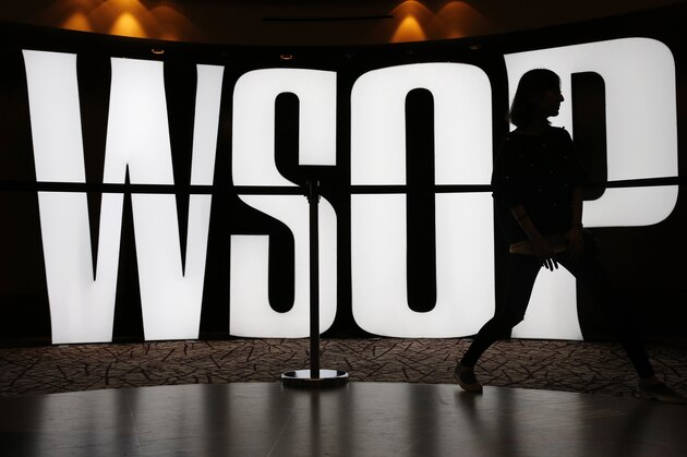 A woman walks by a sign before the start of the World Series of Poker, Sunday, Nov. 8, 2015, in Las Vegas. Sunday night was the first of three days of marathon-length poker-playing before crowning a new champion and awarding more than $7 million to the winner. (AP Photo/John Locher)