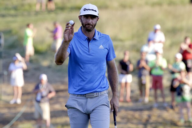 Dustin Johnson waves after a birdie on the sixth hole during the rain delayed second round of the U.S. Open golf championship at Oakmont Country Club on Friday, June 17, 2016, in Oakmont, Pa. (AP Photo/Gene J. Puskar)
