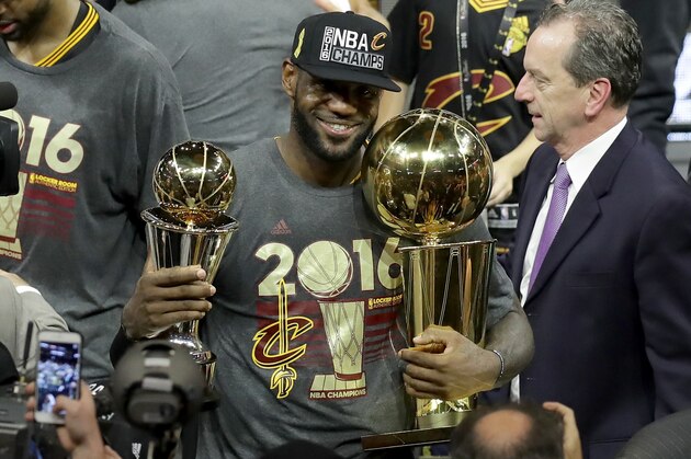 OAKLAND, CA - JUNE 19:  LeBron James #23 of the Cleveland Cavaliers holds the Larry O'Brien Championship Trophy and the Bill Russell NBA Finals Most Valuable Player Award after defeating the Golden State Warriors 93-89 in Game 7 of the 2016 NBA Finals at ORACLE Arena on June 19, 2016 in Oakland, California. NOTE TO USER: User expressly acknowledges and agrees that, by downloading and or using this photograph, User is consenting to the terms and conditions of the Getty Images License Agreement.  (Photo by Ronald Martinez/Getty Images)