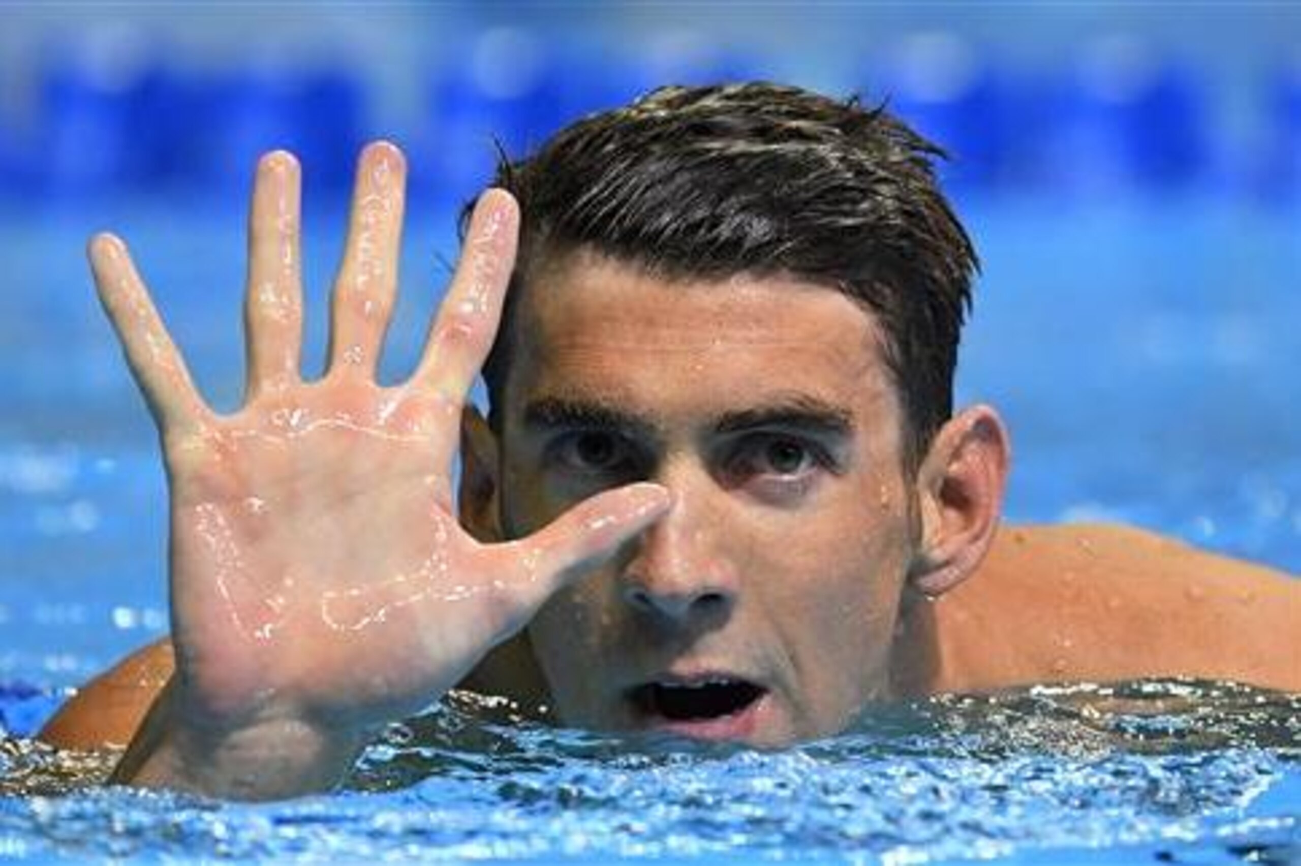 Michael Phelps gestures after winning the men's 200-meter butterfly at the U.S. Olympic swimming trials, Wednesday, June 29, 2016, in Omaha, Neb. Phelps qualified for his fifth Summer Games. (AP Photo/Mark J. Terrill)