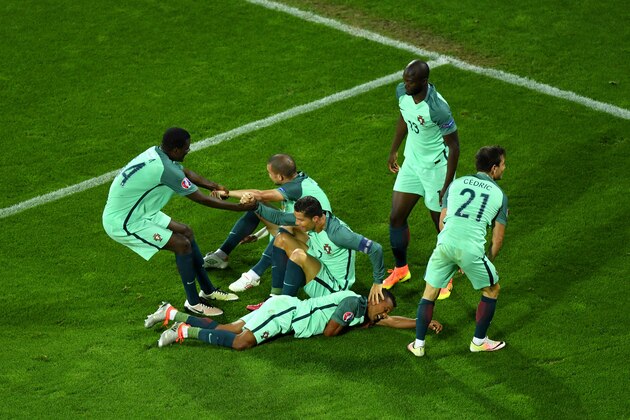 LENS, FRANCE - JUNE 25:  Cristiano Ronaldo and Portugal players celebrate their team's first goal during the UEFA EURO 2016 round of 16 match between Croatia and Portugal at Stade Bollaert-Delelis on June 25, 2016 in Lens, France.  (Photo by Shaun Botterill/Getty Images)