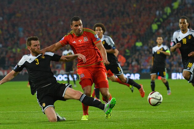 Wales's midfielder Hal Robson-Kanu (2L) is tackled by Belgium's defender Nicolas Lombaerts (L) during the Euro 2016 qualifying group B football match between Wales and Belgium at Cardiff City Stadium in Cardiff, south Wales, on June 12, 2015. Wales held on to a 1-0 lead given to them by the first half strike of Gareth Bale to win the match and go top of group B.  AFP PHOTO / GLYN KIRK        (Photo credit should read GLYN KIRK/AFP/Getty Images)