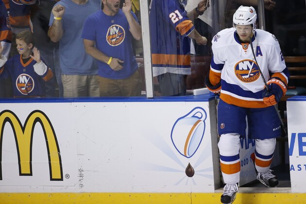 New York Islanders right wing Kyle Okposo hits the ice as fans look on during warmups before the start of Game 2 in a first-round NHL hockey Stanley Cup playoff series against the Florida Panthers, Friday, April 15, 2016, in Sunrise, Fla. (AP Photo/Wilfredo Lee)