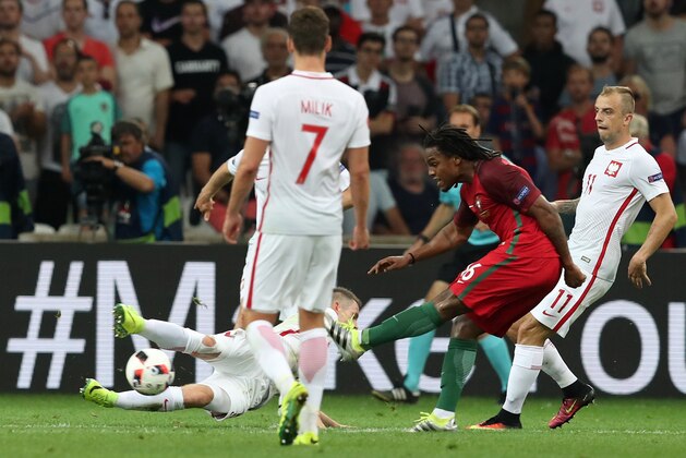Portugal's Renato Sanches, center, scores his side’s first goal during the Euro 2016 quarterfinal soccer match between Poland and Portugal, at the Velodrome stadium in Marseille, France, Thursday, June 30, 2016. (AP Photo/Thanassis Stavrakis)