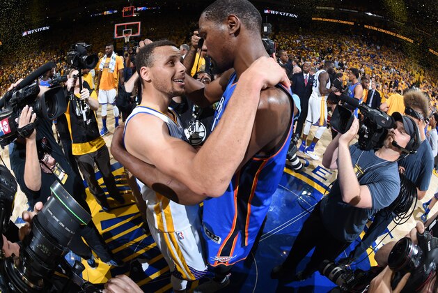 OAKLAND, CA - MAY 30: Stephen Curry #30 of the Golden State Warriors hugs Kevin Durant #35 of the Oklahoma City Thunder after Game Seven of the Western Conference Finals during the 2016 NBA Playoffs on May 30, 2016 at ORACLE Arena in Oakland, California. NOTE TO USER: User expressly acknowledges and agrees that, by downloading and or using this Photograph, user is consenting to the terms and conditions of the Getty Images License Agreement. Mandatory Copyright Notice: Copyright 2016 NBAE (Photo by Andrew Bernstein/NBAE via Getty Images)