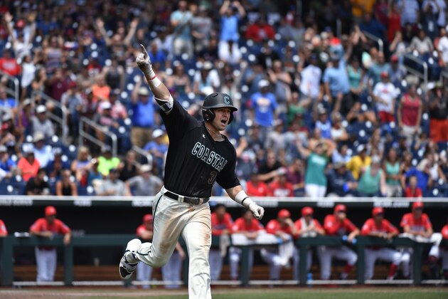 Coastal Carolina's G.K. Young celebrates his two-run home run against Arizona pitcher Bobby Dalbec in the  sixth inning in Game 3 of the NCAA College World Series baseball finals in Omaha, Neb., Thursday, June 30, 2016. (AP Photo/Ted Kirk)