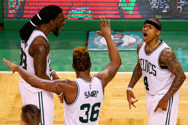 BOSTON, MA - APRIL 24:  Isaiah Thomas #4 of the Boston Celtics celebrates with Marcus Smart #36 and Jae Crowder #99 after hitting a three pointer during overtime of Game Four of the Eastern Conference Quarterfinals against the Atlanta Hawks during the 2016 NBA Playoffs at TD Garden on April 24, 2016 in Boston, Massachusetts. The Celtics defeated the Hawks 104-95. NOTE TO USER User expressly acknowledges and agrees that, by downloading and or using this photograph, user is consenting to the terms and conditions of the Getty Images License Agreement.  (Photo by Maddie Meyer/Getty Images)