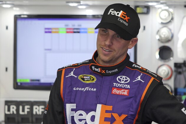 Denny Hamlin waits outside his car before practice for today's NASCAR Sprint Cup series All-Star auto race at Charlotte Motor Speedway in Concord, N.C., Saturday, May 21, 2016. (AP Photo/Bob Jordan)