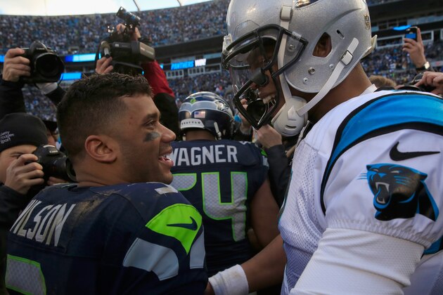 CHARLOTTE, NC - JANUARY 17:   Cam Newton #1 of the Carolina Panthers meets  Russell Wilson #3 of the Seattle Seahawks on the field after the NFC Divisional Playoff Game at Bank of America Stadium on January 17, 2016 in Charlotte, North Carolina.  (Photo by Jamie Squire/Getty Images)