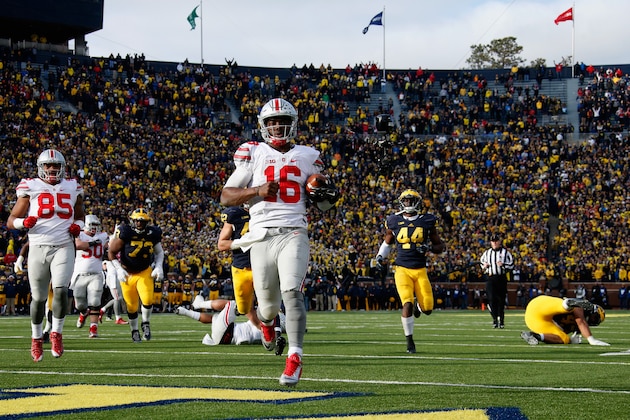 ANN ARBOR, MI - NOVEMBER 28:  Quarterback J.T. Barrett #16 of the Ohio State Buckeyes rushes for a fourth quarter touchdown against the Michigan Wolverines at Michigan Stadium on November 28, 2015 in Ann Arbor, Michigan.  (Photo by Gregory Shamus/Getty Images)