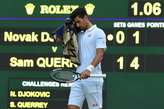 Serbia's Novak Djokovic reacts while playing US player Sam Querrey during their men's singles third round match on the fifth day of the 2016 Wimbledon Championships at The All England Lawn Tennis Club in Wimbledon, southwest London, on July 1, 2016. / AFP / GLYN KIRK / RESTRICTED TO EDITORIAL USE        (Photo credit should read GLYN KIRK/AFP/Getty Images)
