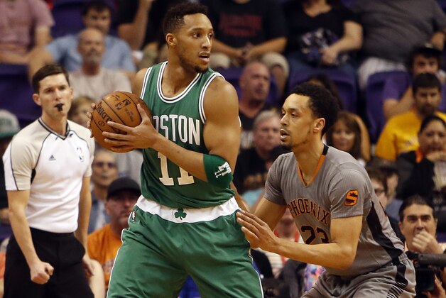 Boston Celtics guard Evan Turner (11) against Phoenix Suns guard John Jenkins (23) in the first quarter during an NBA basketball game, Saturday, March 26, 2016, in Phoenix. (AP Photo/Rick Scuteri)