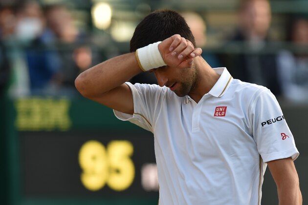 Serbia's Novak Djokovic reacts while playing US player Sam Querrey during their men's singles third round match on the fifth day of the 2016 Wimbledon Championships at The All England Lawn Tennis Club in Wimbledon, southwest London, on July 1, 2016. / AFP / GLYN KIRK / RESTRICTED TO EDITORIAL USE        (Photo credit should read GLYN KIRK/AFP/Getty Images)