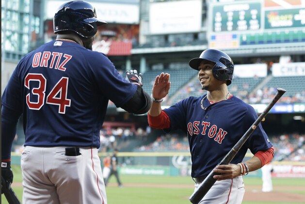 Boston Red Sox's David Ortiz (34) congratulates Mookie Betts after he scored from third base on a Dustin Pedroia single against the Houston Astros in the first inning of a baseball game Friday, April 22, 2016, in Houston. (AP Photo/Pat Sullivan)