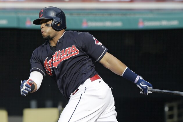 Cleveland Indians' Carlos Santana hits an RBI-single off Kansas City Royals relief pitcher Scott Alexander in the seventh inning of a baseball game, Sunday, June 5, 2016, in Cleveland. Tyler Naquin scored on the play. (AP Photo/Tony Dejak)