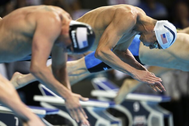 Michael Phelps, right, dives at the start of the men's 200-meter individual medley final at the U.S. Olympic swimming trials, in Omaha, Neb., Friday, July 1, 2016. Phelps won the race. (AP Photo/Nati Harnik)