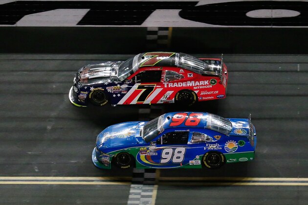 DAYTONA BEACH, FL - JULY 01: Justin Allgaier, driver of the #7 TradeMark Nitrogen Chevrolet, leads Aric Almirola, driver of the #98 Fresh From Florida Ford, during the NASCAR XFINITY Series Subway Firecracker 250 at Daytona International Speedway on July 1, 2016 in Daytona Beach, Florida.  (Photo by Chris Trotman/Getty Images)