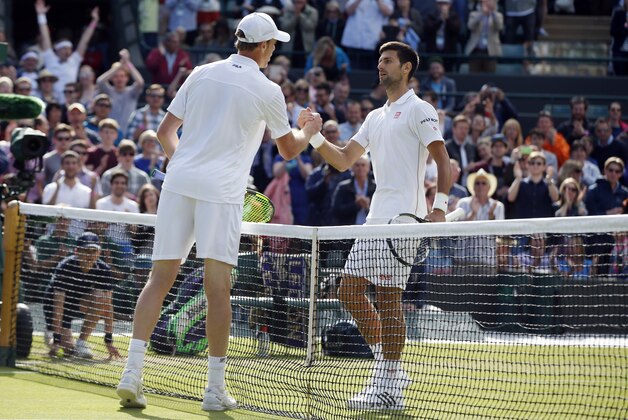 Sam Querrey of the U.S, left, shakes hands with Novak Djokovic of Serbia after beating him in their men's singles match on day six of the Wimbledon Tennis Championships in London, Saturday, July 2, 2016. (AP Photo/Alastair Grant)