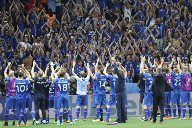 Iceland players celebrate with their supporters at the end of the Euro 2016 round of 16 soccer match between England and Iceland, at the Allianz Riviera stadium in Nice, France, Monday, June 27, 2016. (AP Photo/Claude Paris) Iceland players celebrate with their supporters at the end of the Euro 2016 round of 16 soccer match between England and Iceland, at the Allianz Riviera stadium in Nice, France, Monday, June 27, 2016. (AP Photo/Claude Paris)