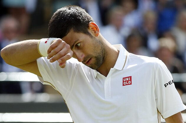 Novak Djokovic of Serbia wipes his face during his men's singles match against Sam Querrey of the U.S on day six of the Wimbledon Tennis Championships in London, Saturday, July 2, 2016. (AP Photo/Alastair Grant)