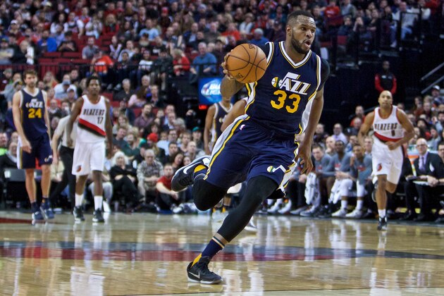 Utah Jazz forward Trevor Booker  drives to the basket during the second half of an NBA basketball game in Portland, Ore., Wednesday, Jan. 13, 2016. The Trail Blazers won 99-85. (AP Photo/Craig Mitchelldyer)