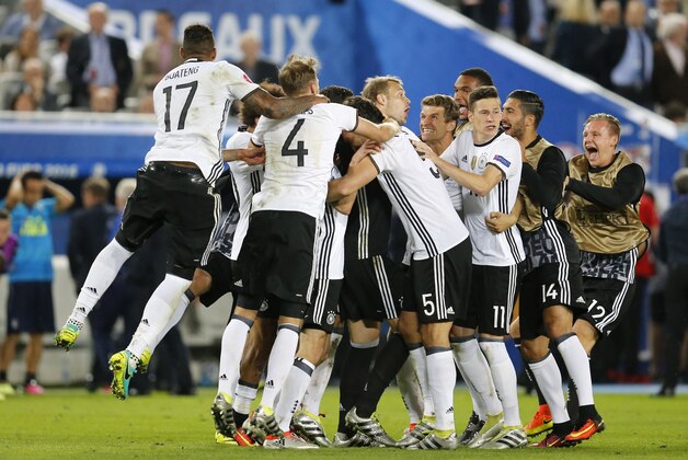 The German team celebrate after winning the Euro 2016 quarterfinal soccer match between Germany and Italy, at the Nouveau Stade in Bordeaux, France, Saturday, July 2, 2016. (AP Photo/Michael Probst)