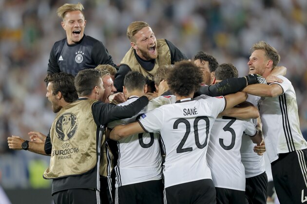Germany's players celebrate after Jonas Hector scored the winning penalty during the Euro 2016 quarterfinal soccer match between Germany and Italy, at the Nouveau Stade in Bordeaux, France, Saturday, July 2, 2016. Germany beat Italy 6-5 in a penalty shootout. (AP Photo/Antonio Calanni)