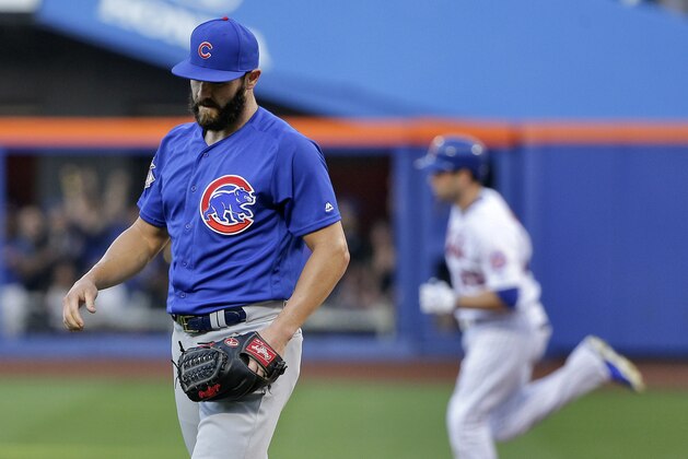 Chicago Cubs starting pitcher Jake Arrieta reacts after giving up a two-run home run to New York Mets' Neil Walker, rear, during the first inning of a baseball game Saturday, July 2, 2016, in New York. (AP Photo/Julie Jacobson)