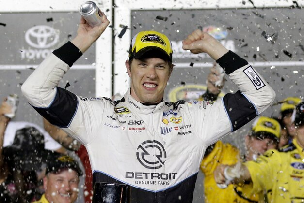 Brad Keselowski celebrates in Victory Lane after winning the NASCAR Sprint Cup Series auto race at Daytona International Speedway, Saturday, July 2, 2016, in Daytona Beach, Fla. (AP Photo/John Raoux)
