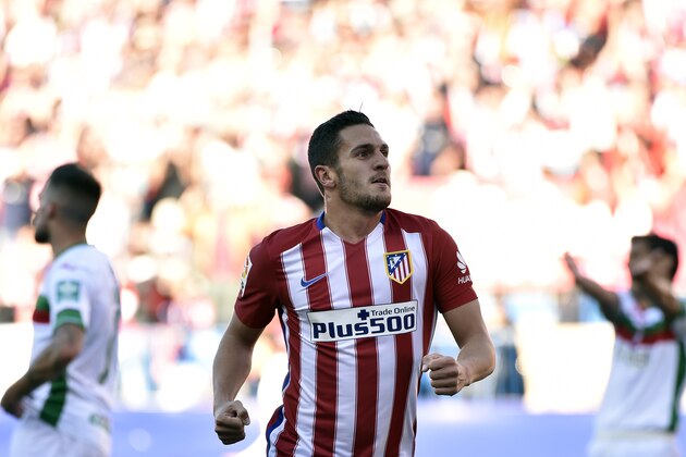 Atletico Madrid's midfielder Koke celebrates after scoring during the Spanish league football match Atletico de Madrid vs Granada CF at the Vicente Calderon stadium in Madrid on April 17, 2016. / AFP / GERARD JULIEN        (Photo credit should read GERARD JULIEN/AFP/Getty Images)