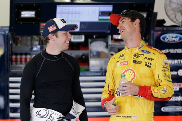 Brad Keselowski, left, and Joey Logano talk in the garage during NASCAR Sprint Cup auto racing practice at Daytona International Speedway, Thursday, June 30, 2016, in Daytona Beach, Fla. (AP Photo/John Raoux)