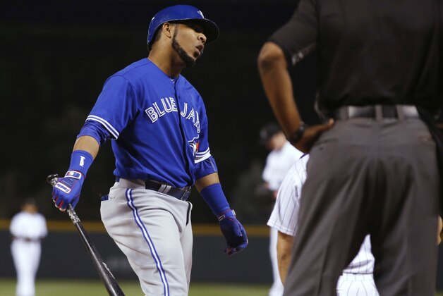 Toronto Blue Jays' Edwin Encarnacion, left, argues a called strike with home plate umpire Laz Diaz while facing Colorado Rockies starting pitcher Eddie Butler during the first inning of a baseball game Tuesday, June 28, 2016, in Denver. (AP Photo/David Zalubowski)