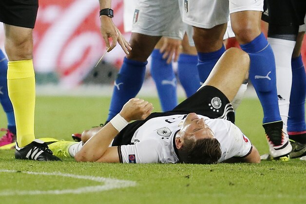 FILE--- Germany's Mario Gomez lies injured on the pitch during the Euro 2016 quarterfinal soccer match between Germany and Italy, at the Nouveau Stade in Bordeaux, France, Saturday, July 2, 2016. Gomez is injured and ruled out for the rest of the tournament. (AP Photo/Michael Probst)