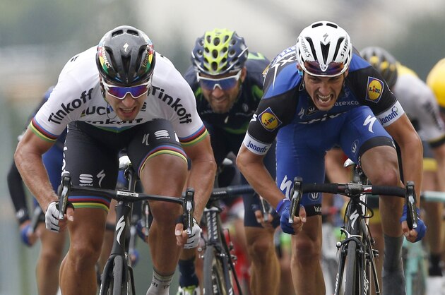 Peter Sagan of Slovakia, left, crosses the finish line ahead of France’s Julian Alaphilippe, right, and Spain's Alejandro Valverde  to win the second stage of the Tour de France cycling race over 183 kilometers (113.7 miles) with start in Saint-Lo and finish in Cherbourg-en-Cotentin, France, Sunday, July 3, 2016. (AP Photo/Christophe Ena)
