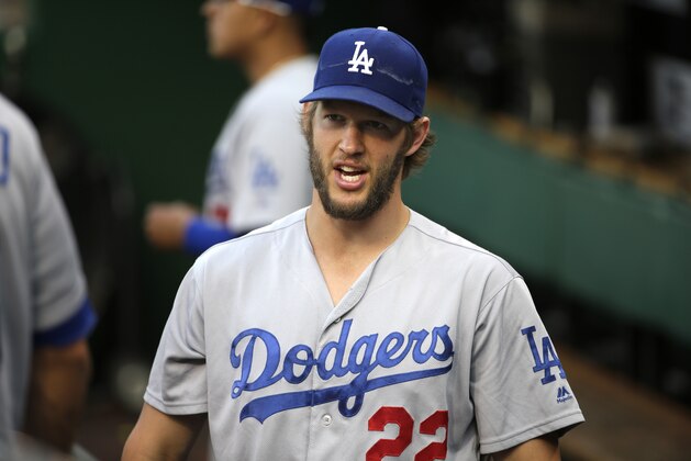 Los Angeles Dodgers starting pitcher Clayton Kershaw walks in the dugout before a baseball game against the Pittsburgh Pirates in Pittsburgh, Saturday, June 25, 2016. (AP Photo/Gene J. Puskar)