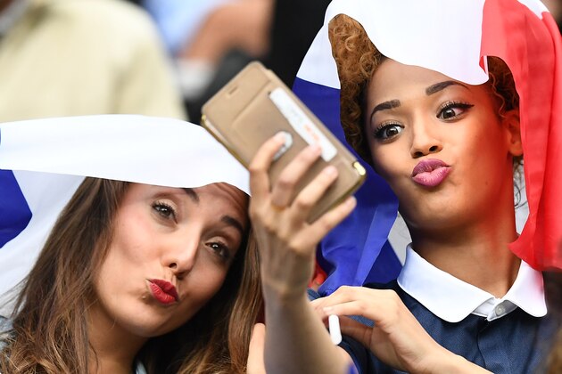 Tiziri Digne (L), the wife of France's defender Lucas Digne and Sephora Coman, wife of France's forward Kingsley Coman, take a selfie prior to the start of the Euro 2016 quarter-final football match between France and Iceland at the Stade de France in Saint-Denis, near Paris, on July 3, 2016. / AFP / FRANCK FIFE        (Photo credit should read FRANCK FIFE/AFP/Getty Images)
