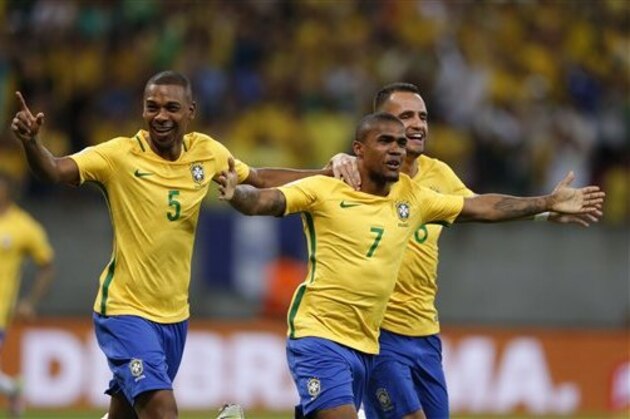 CORRECTS NAME OF GOAL SCORER - Brazil's Douglas Costa, center, celebrates with teammates Fernandinho, left, and Renato Augusto after scoring against Uruguay during a 2018 World Cup qualifying soccer match at the Pernambuco Arena, in Recife, Brazil, Friday, March 25, 2016. (AP Photo/Leo Correa)