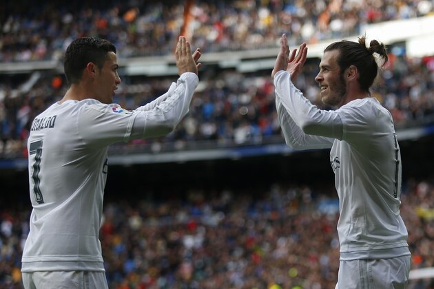 Real Madrid's Gareth Bale, right, celebrates with teammate Cristiano Ronaldo after scoring a goal against Celta during a Spanish La Liga soccer match between Real Madrid and Celta Vigo at the Santiago Bernabeu stadium in Madrid, Saturday, March 5, 2016. Ronaldo scored four goals and Bale one in Real Madrid's 7-1 victory.  (AP Photo/Francisco Seco)