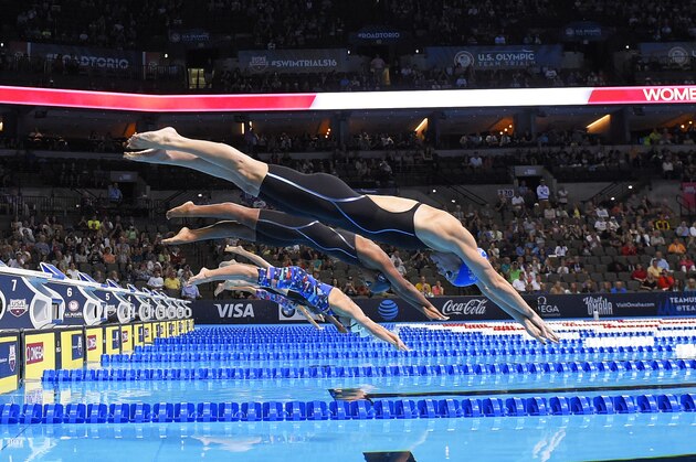 Amanda Weir, right, dives at the start of the women's 50-meter freestyle final at the U.S. Olympic swimming trials, Sunday, July 3, 2016, in Omaha, Neb. (AP Photo/Mark J. Terrill)