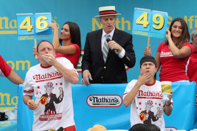 FILE - In this July 4, 2015 file photo, Joey Chestnut, left, and Matt Stonie compete in Nathan's Famous Fourth of July International Hot Dog Eating Contest men's competition in the Coney Island section of the Brooklyn borough of New York. On the eve of the World Series, where hot dogs are a staple in the stands, the World Health Organization on Monday, Oct. 26, 2015 labeled the all-American wiener, bacon and other processed meats as being