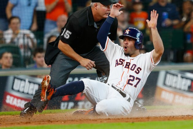 HOUSTON, TX - JULY 02:  Jose Altuve #27 of the Houston Astros scores in the third inning as he slides in front of home plate umpire Tim Timmons at Minute Maid Park on July 2, 2016 in Houston, Texas.  (Photo by Bob Levey/Getty Images)