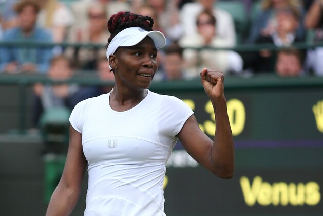 US player Venus Williams celebrates beating Spain's Carla Suarez Navarro during their women's singles fourth round match on the eighth day of the 2016 Wimbledon Championships at The All England Lawn Tennis Club in Wimbledon, southwest London, on July 4, 2016. / AFP / JUSTIN TALLIS / RESTRICTED TO EDITORIAL USE        (Photo credit should read JUSTIN TALLIS/AFP/Getty Images)