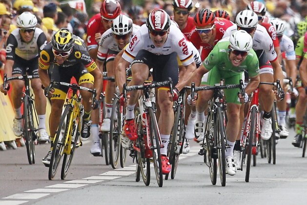 Britain's Mark Cavendish, wearing the best sprinter's green jersey, sprints towards the finish line to win ahead of Germany's Andre Greipel, center in white, and France’s Brian Coquard, second left, during the third stage of the Tour de France cycling race over 223.5 kilometers (138.6 miles) with start in Granville and finish in Angers, France, Monday, July 4, 2016. (AP Photo/Christophe Ena)