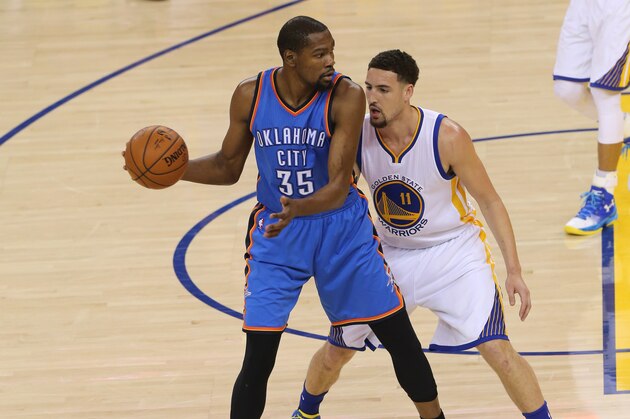 OAKLAND, CA - MAY 30:  Kevin Durant #35 of the Oklahoma City Thunder handles the ball against Klay Thompson #11 of the Golden State Warriors in Game Seven of the Western Conference Finals during the 2016 NBA Playoffs on May 30, 2016 at Oracle Arena in Oakland, California. NOTE TO USER: User expressly acknowledges and agrees that, by downloading and or using this photograph, user is consenting to the terms and conditions of Getty Images License Agreement. Mandatory Copyright Notice: Copyright 2016 NBAE (Photo by Layne Murdoch/NBAE via Getty Images)